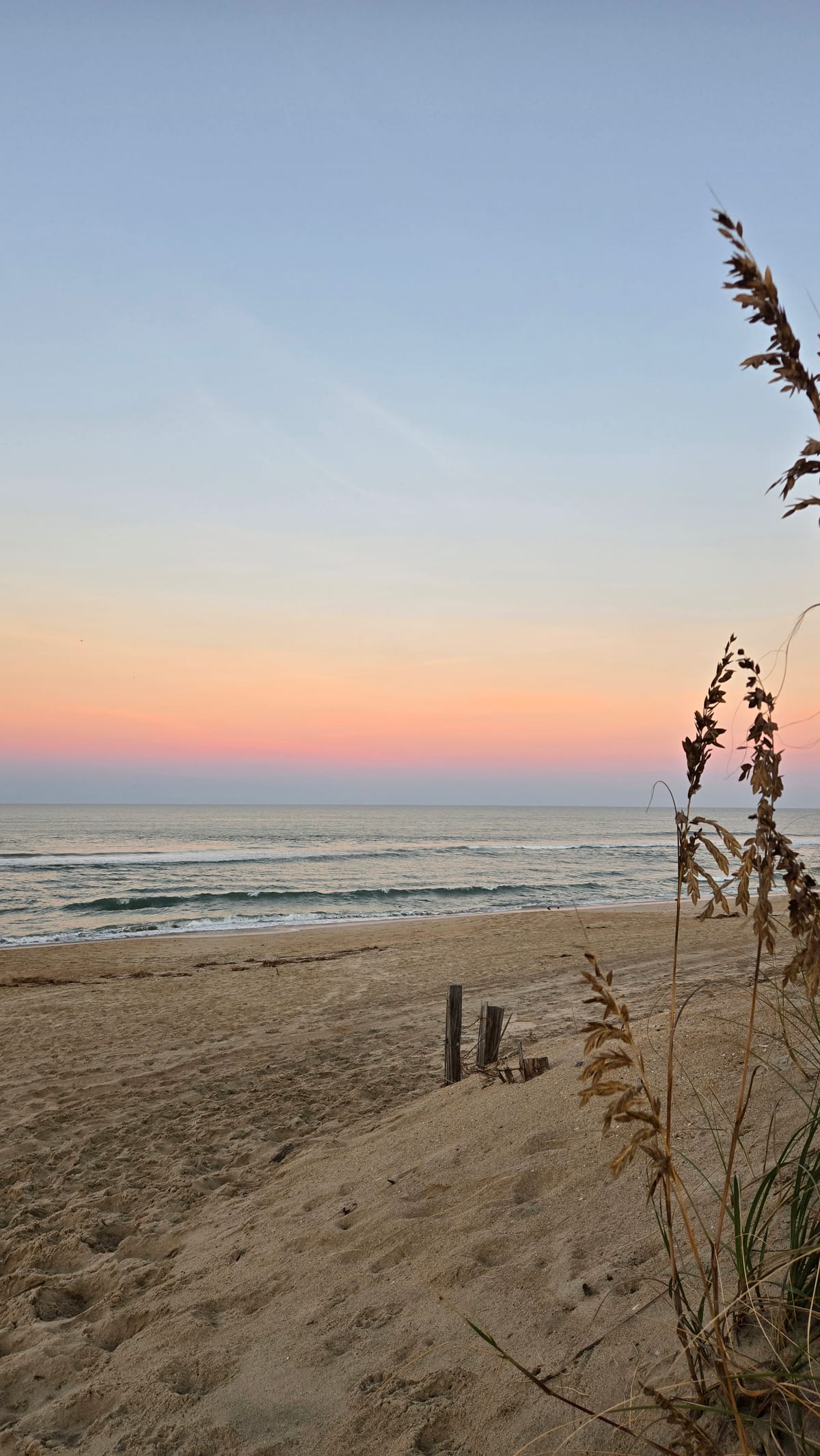 Cotton candy pink and orange sunset over the beach on the Outer Banks